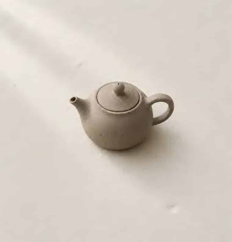 A small unglazed stoneware teapot